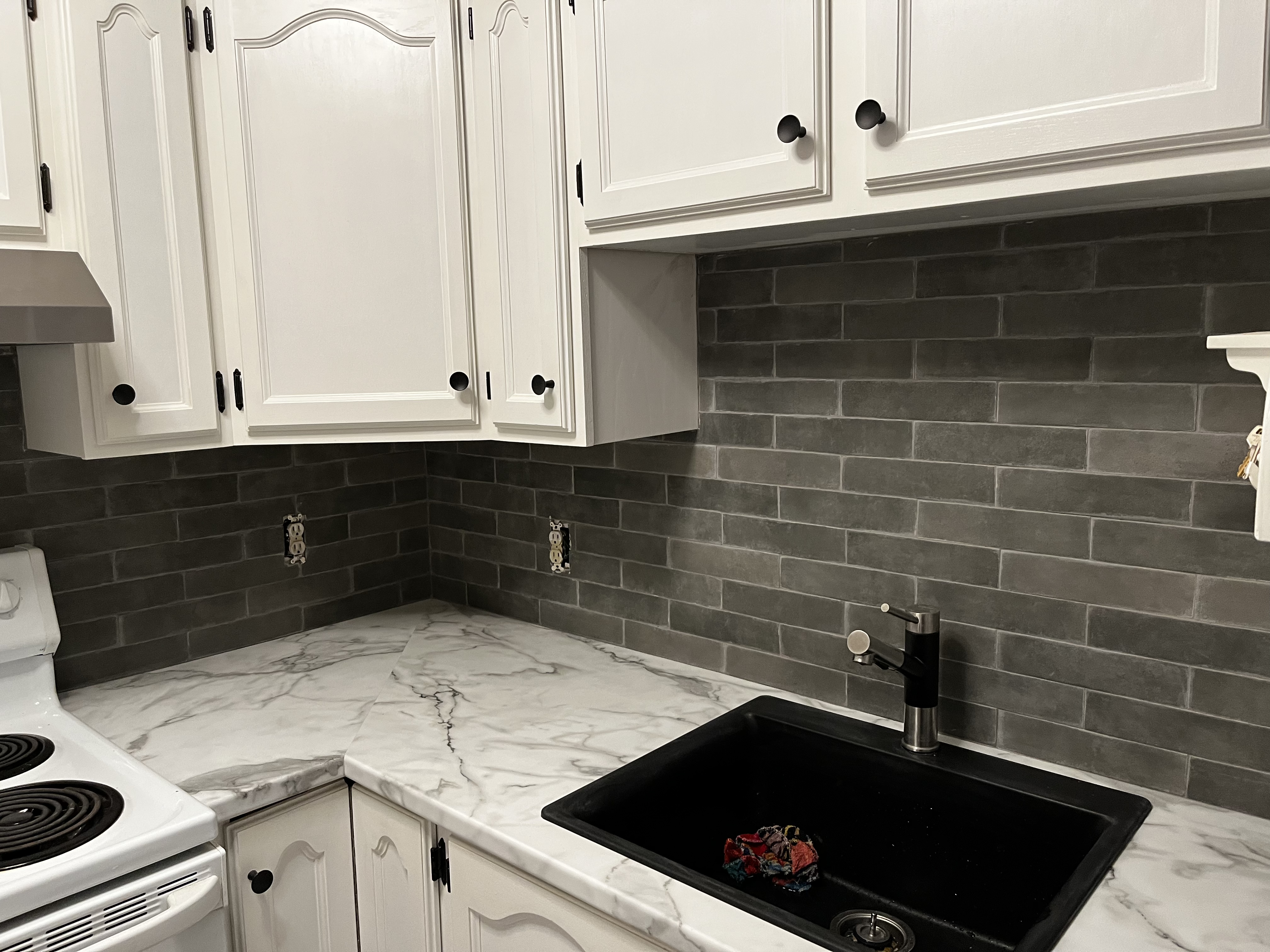Classy Postform Laminate counters with tile backsplash and granite sink