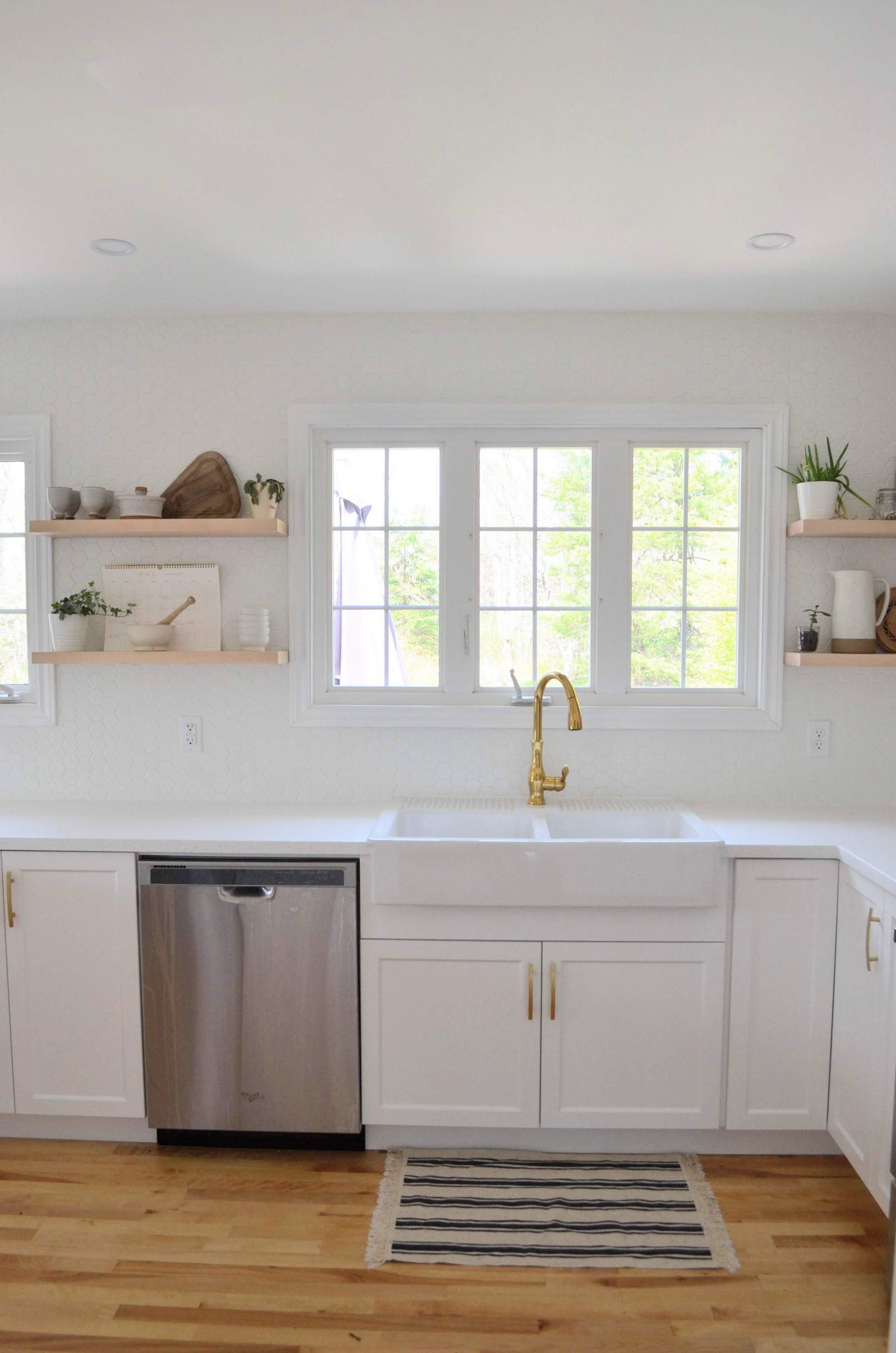All white: Quartz counters, apron sink and doors