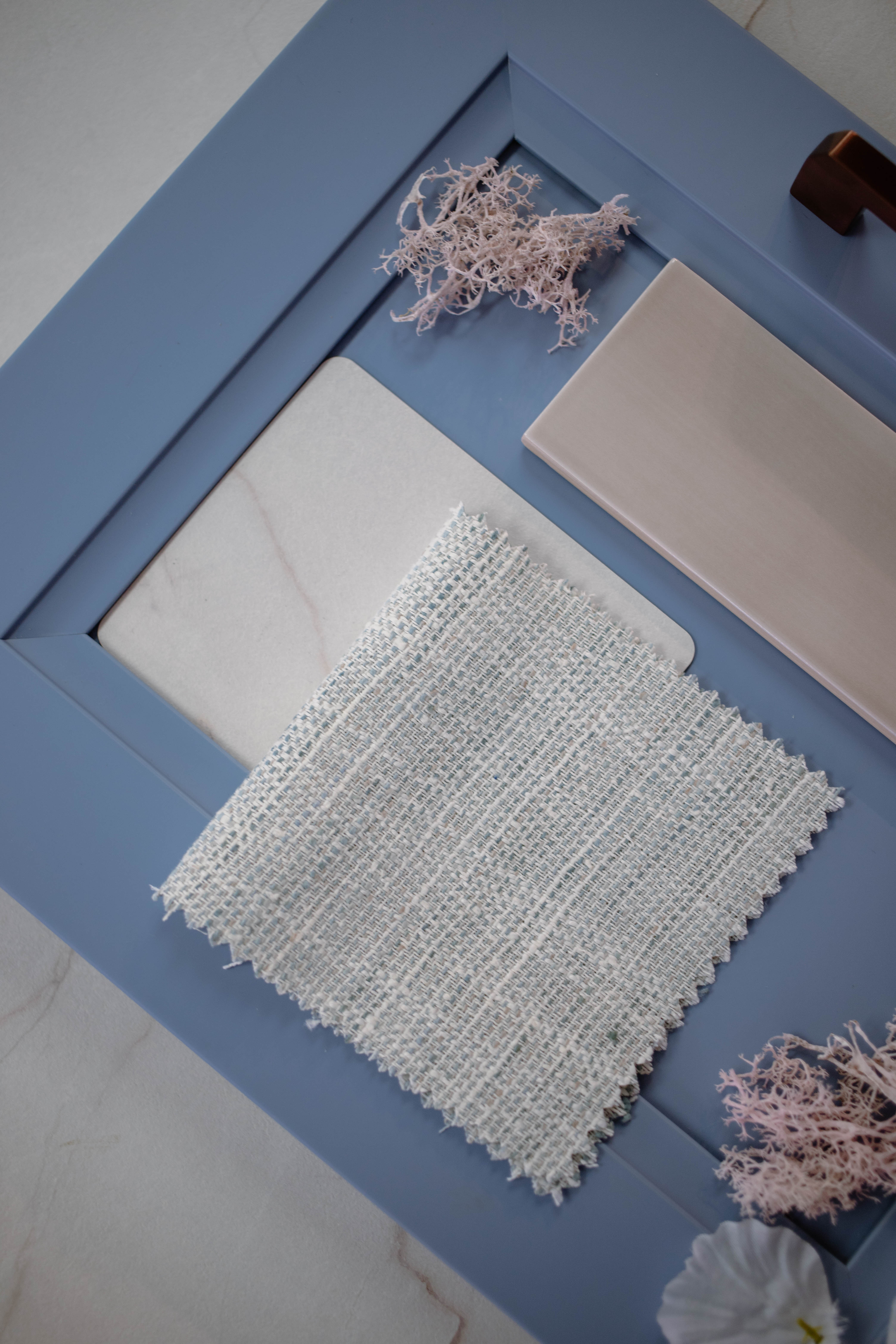 display of blind swatches in a light grey with beige and light blue throughout 