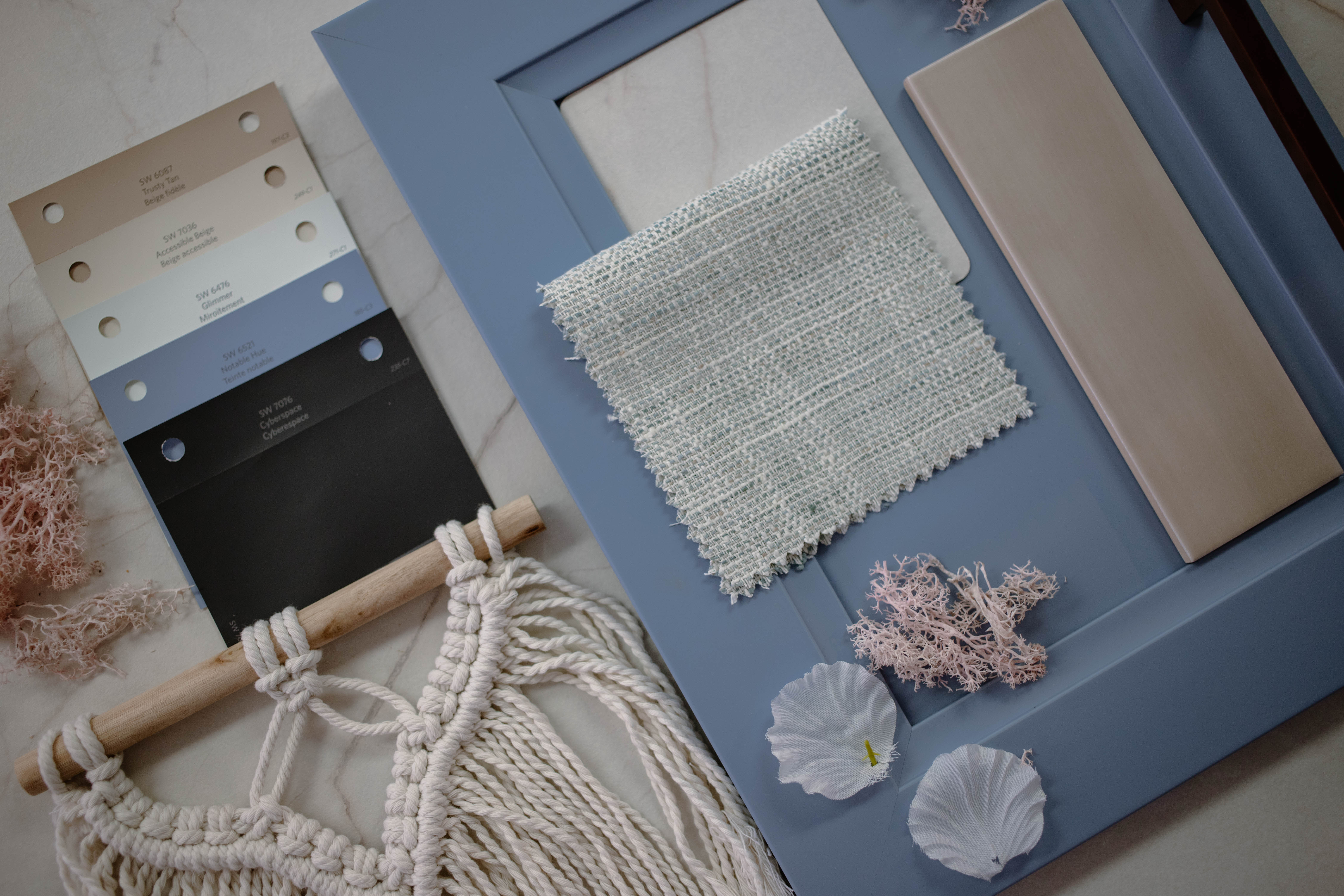 Flat lay photography of white perito countertop with pallets of light and dark blues and beiges