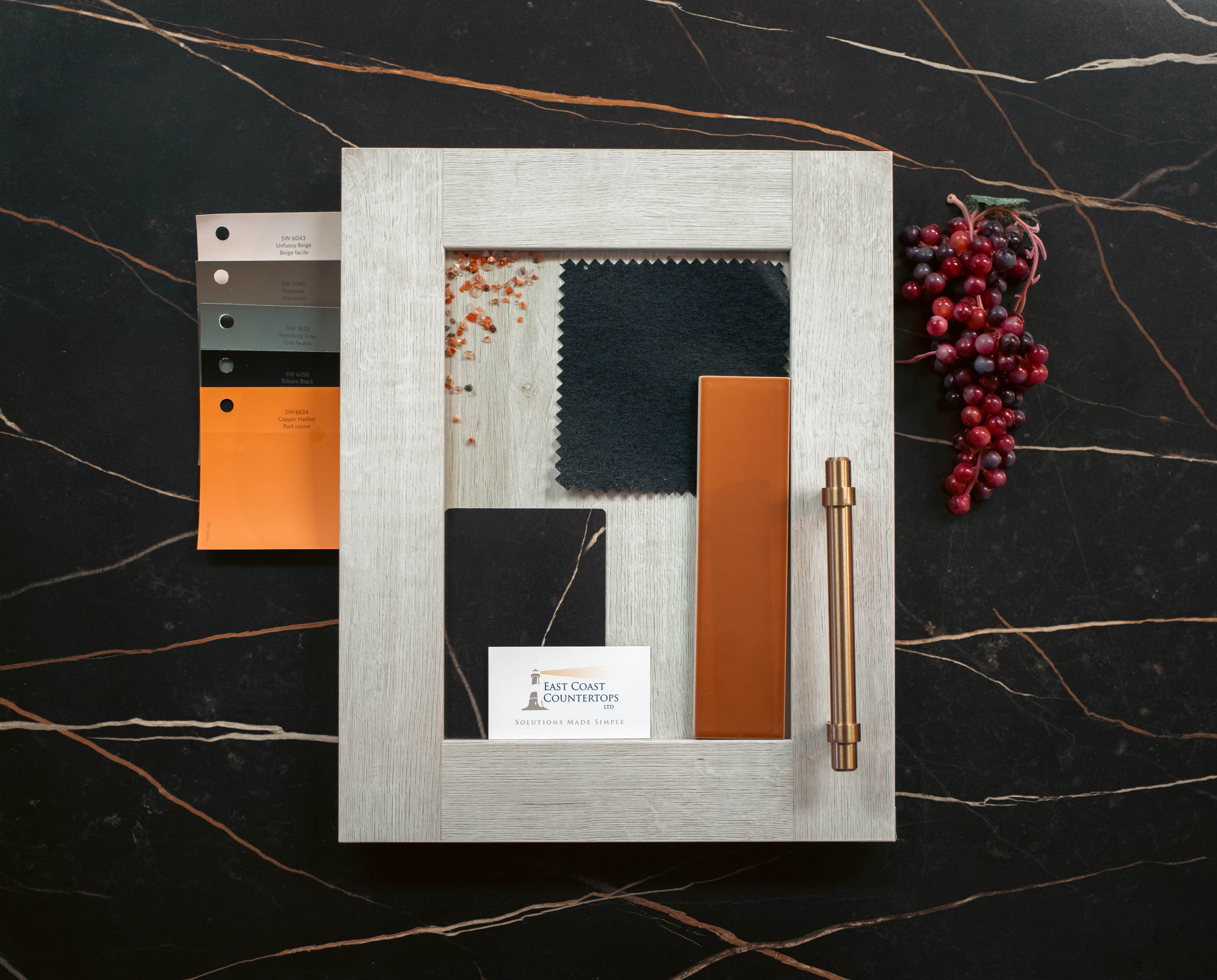 Flat lay mood board featuring Formica Sahara Noir laminate sample, Prestolam wood finish, and terracotta tiles.